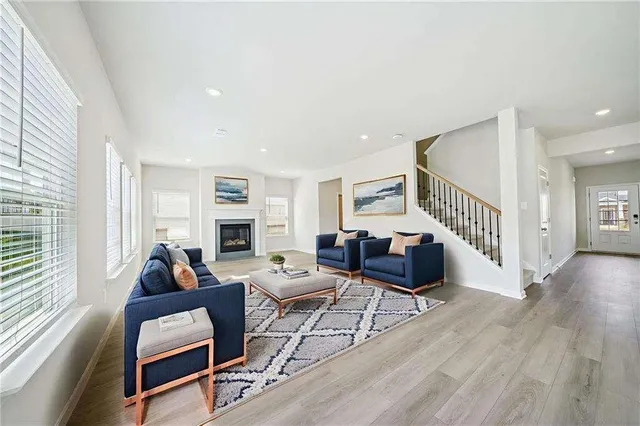 a living room with fireplace furniture and a wooden floor