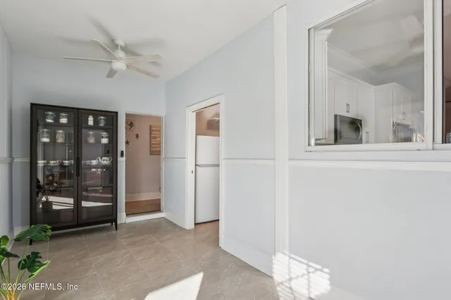 a bedroom with bed a flat tv screen and a potted plant