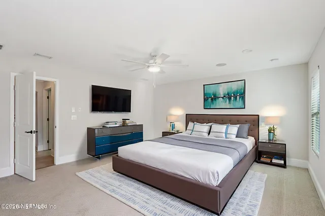 an empty room with windows and ceiling fan