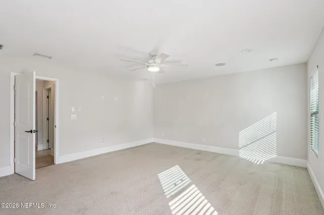 a view of a livingroom with a ceiling fan and window