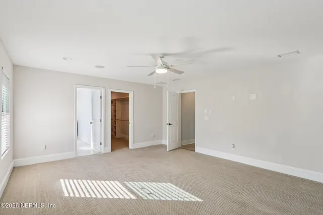 a bathroom with a sink vanity granite toilet and a mirror