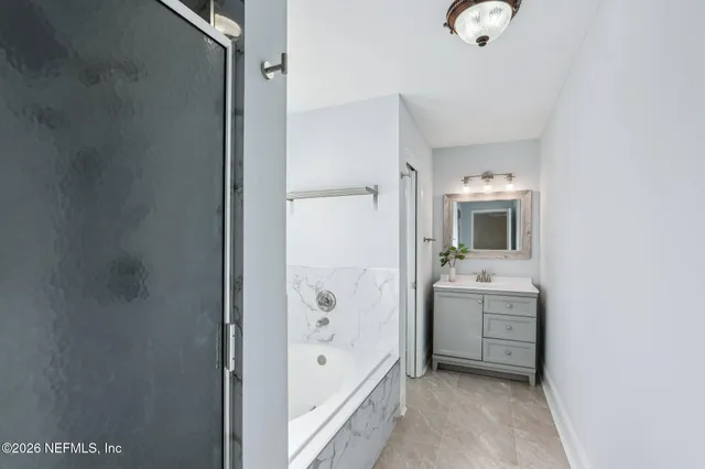 a bathroom with a tub and shower