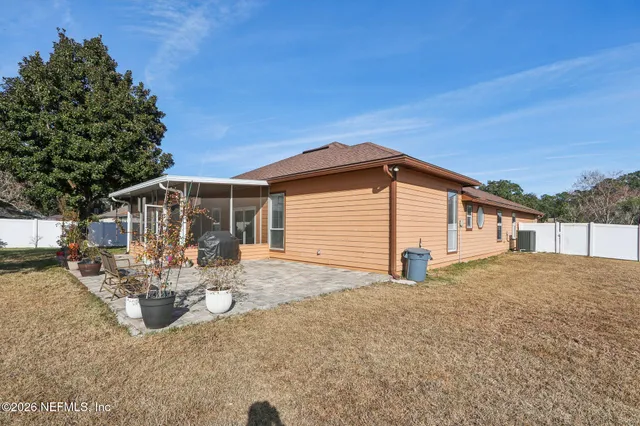 a view of a house with backyard and sitting area