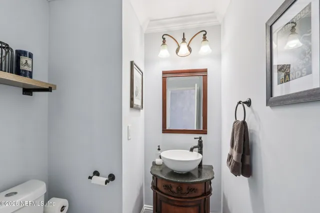 a kitchen with sink a stove and chairs