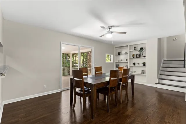 a kitchen with a refrigerator a sink a window and cabinets