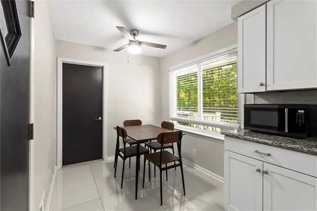 a view of a room with wooden floor and white walls