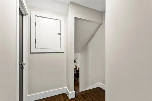 a bedroom with a bed a dresser and a window