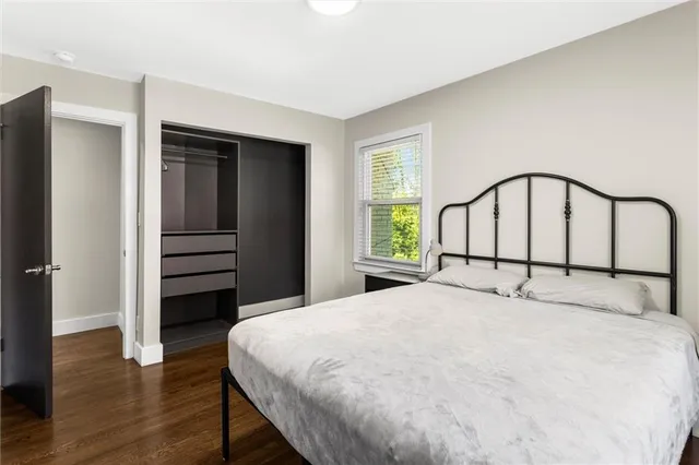 a view of a hallway with wooden floor and entryway