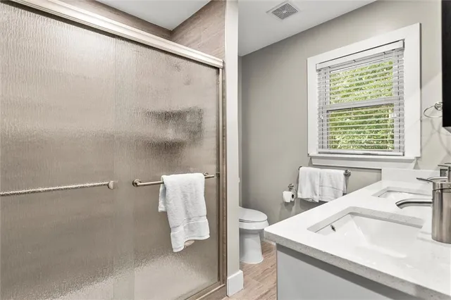 a kitchen with a table chairs refrigerator and microwave