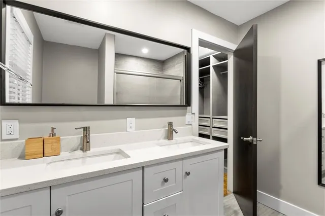 a kitchen with granite countertop a refrigerator a stove a sink a dining table and chairs