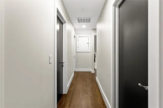 a dining hall with stainless steel appliances a dining table and chairs with wooden floor