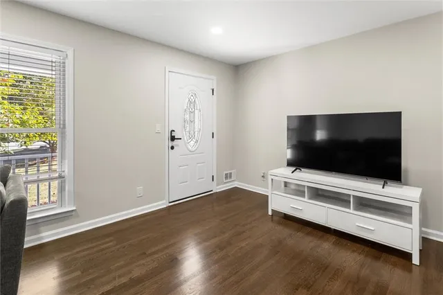 a living room with furniture and wooden floor