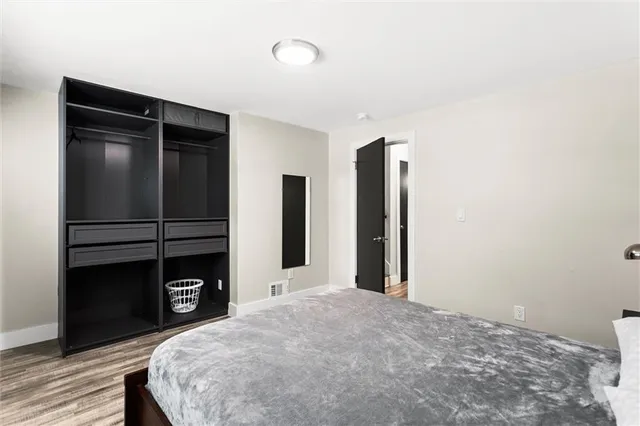 a large bed sitting in a bedroom next to a window