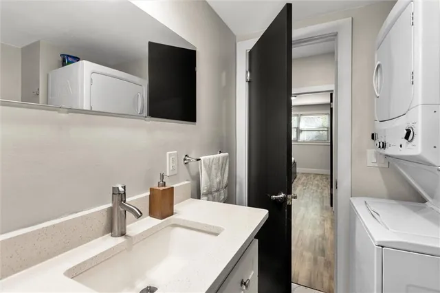 a view of swimming pool with lawn chairs and large trees