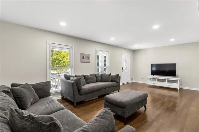 a living room with furniture and a wooden floor