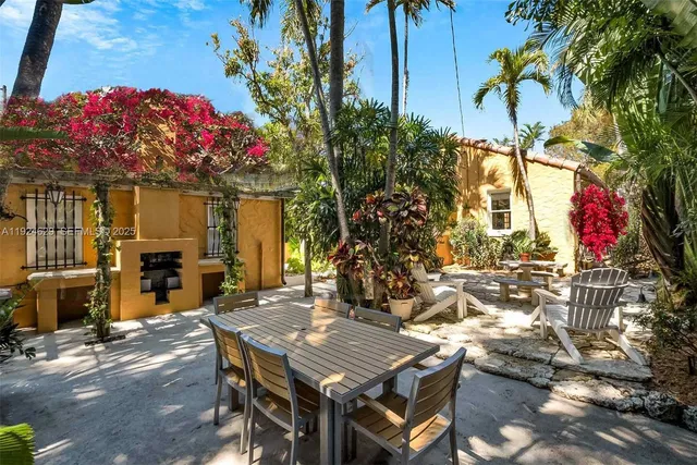 a view of a patio with table and chairs and potted plants