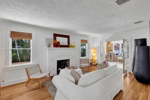 a living room with furniture fireplace and a window