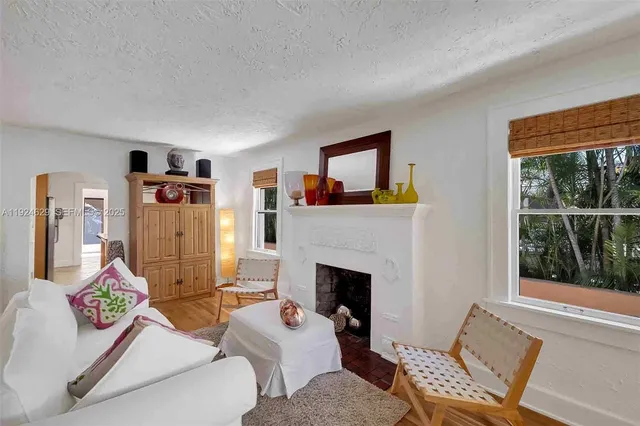 a living room with furniture and a fireplace