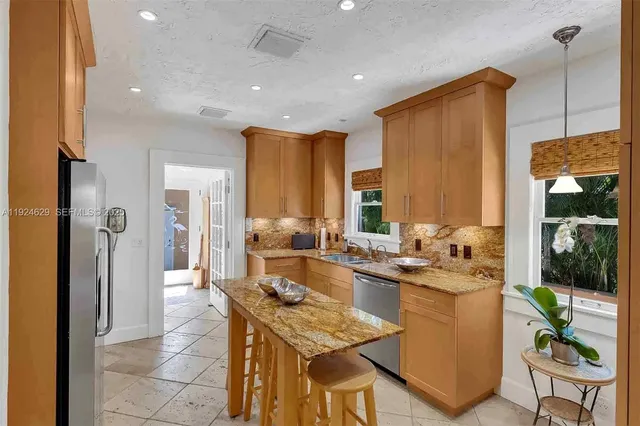a kitchen with a table and chairs in it