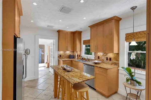 a kitchen with a table and chairs in it