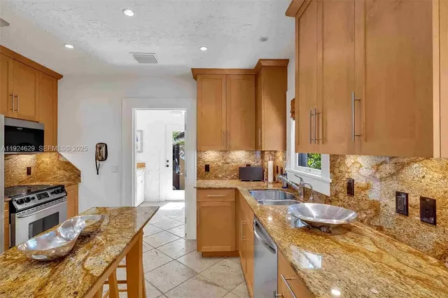 a kitchen with sink refrigerator and stove