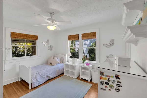 a bedroom with furniture and a large window
