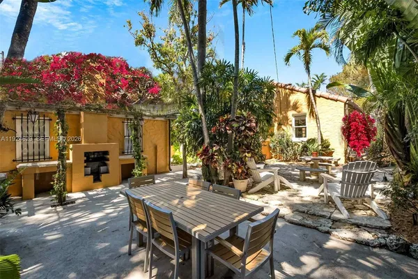 a view of a patio with table and chairs and potted plants