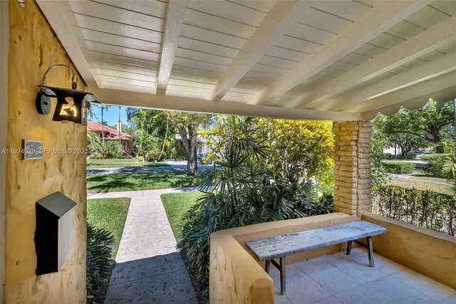 a view of yard from deck with patio