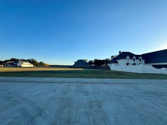 a view of a herd of animals grazing on a road