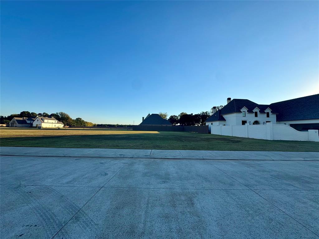 a view of a herd of animals grazing on a road