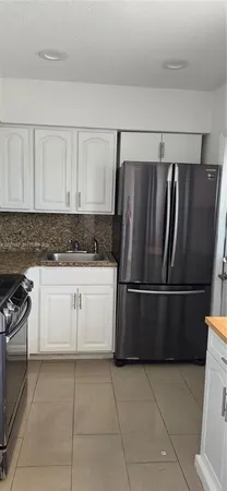 a kitchen with appliances and cabinets