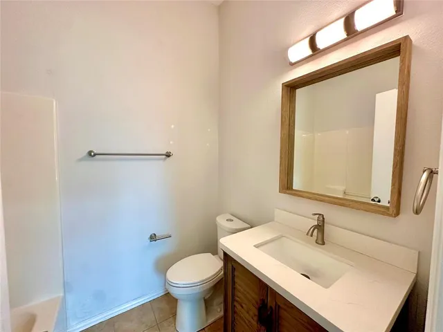 a bathroom with a sink toilet and mirror