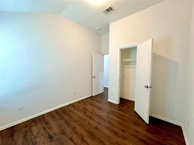 an empty room with wooden floor