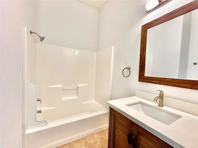 a bathroom with a granite countertop sink mirror and a