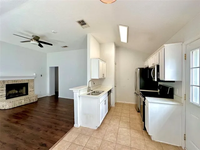 a kitchen with stainless steel appliances a stove a microwave and a refrigerator
