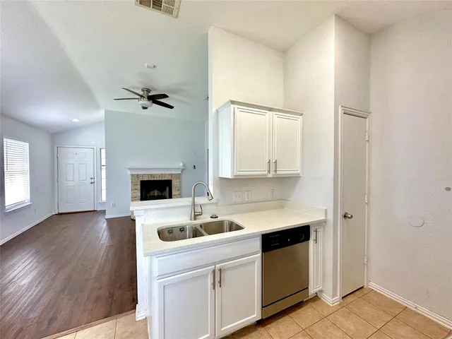 a kitchen with a sink appliances and cabinets