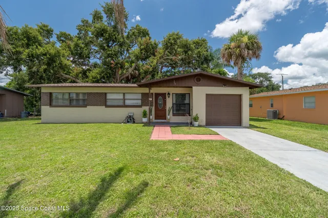 a view of a house with pool and a yard
