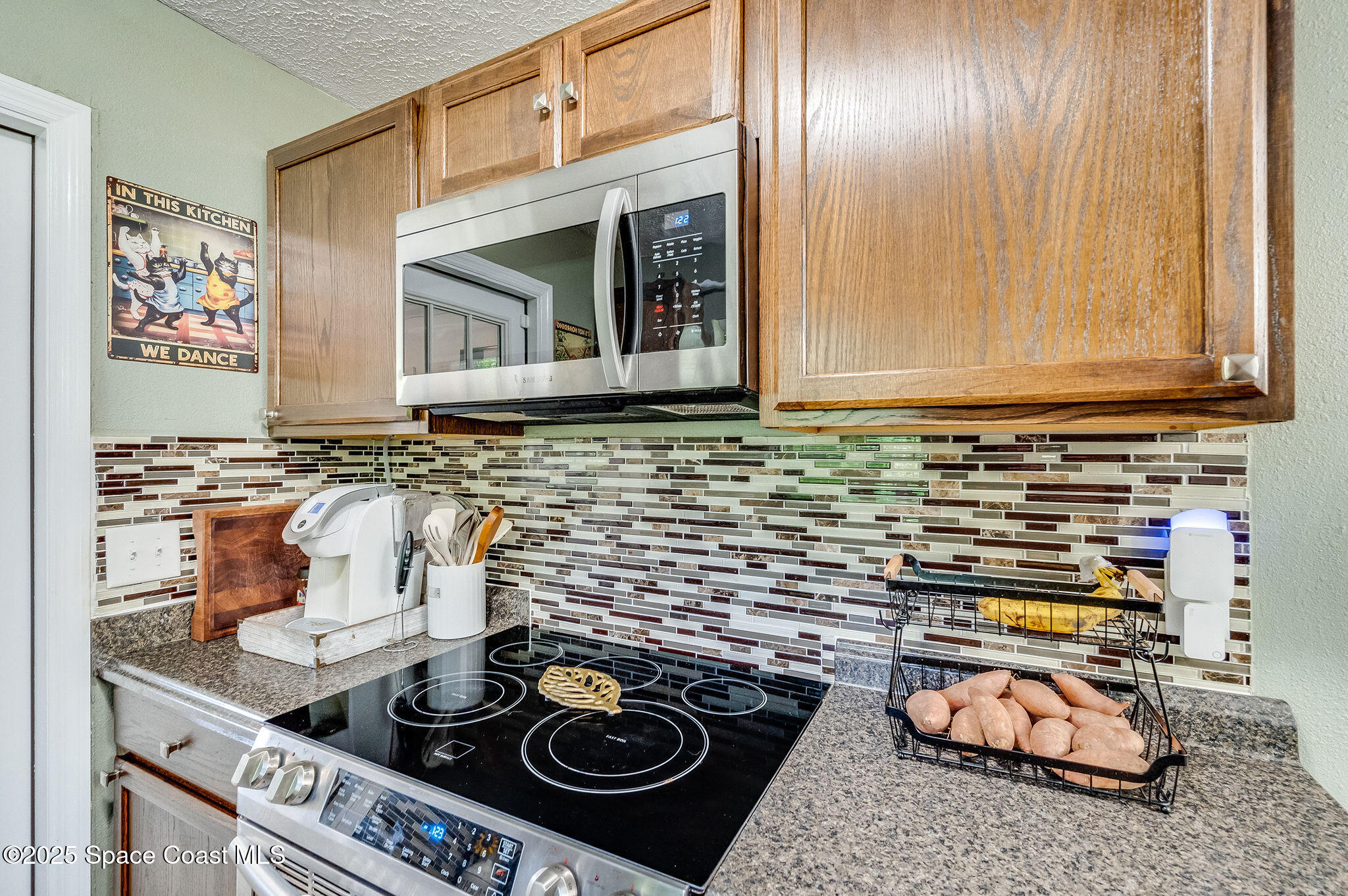 369 Western Avenue Cocoa, FL 32926 - Photo 12 of 38 a kitchen with a stove and a microwave