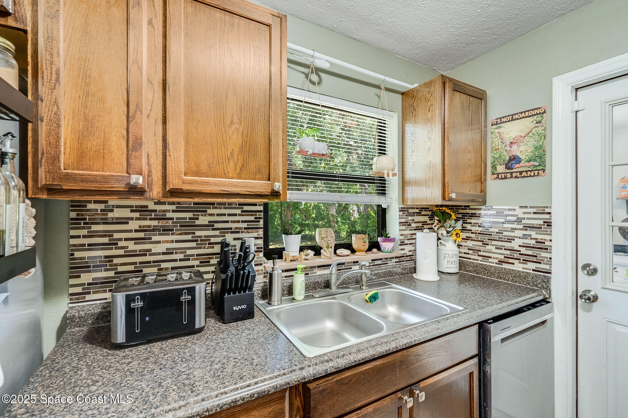 369 Western Avenue Cocoa, FL 32926 - Photo 13 of 38 a kitchen with stainless steel appliances a sink a stove and a wooden cabinets