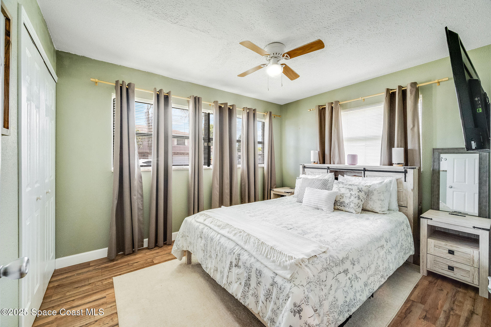 369 Western Avenue Cocoa, FL 32926 - Photo 15 of 38 a bedroom with a large bed and a chandelier