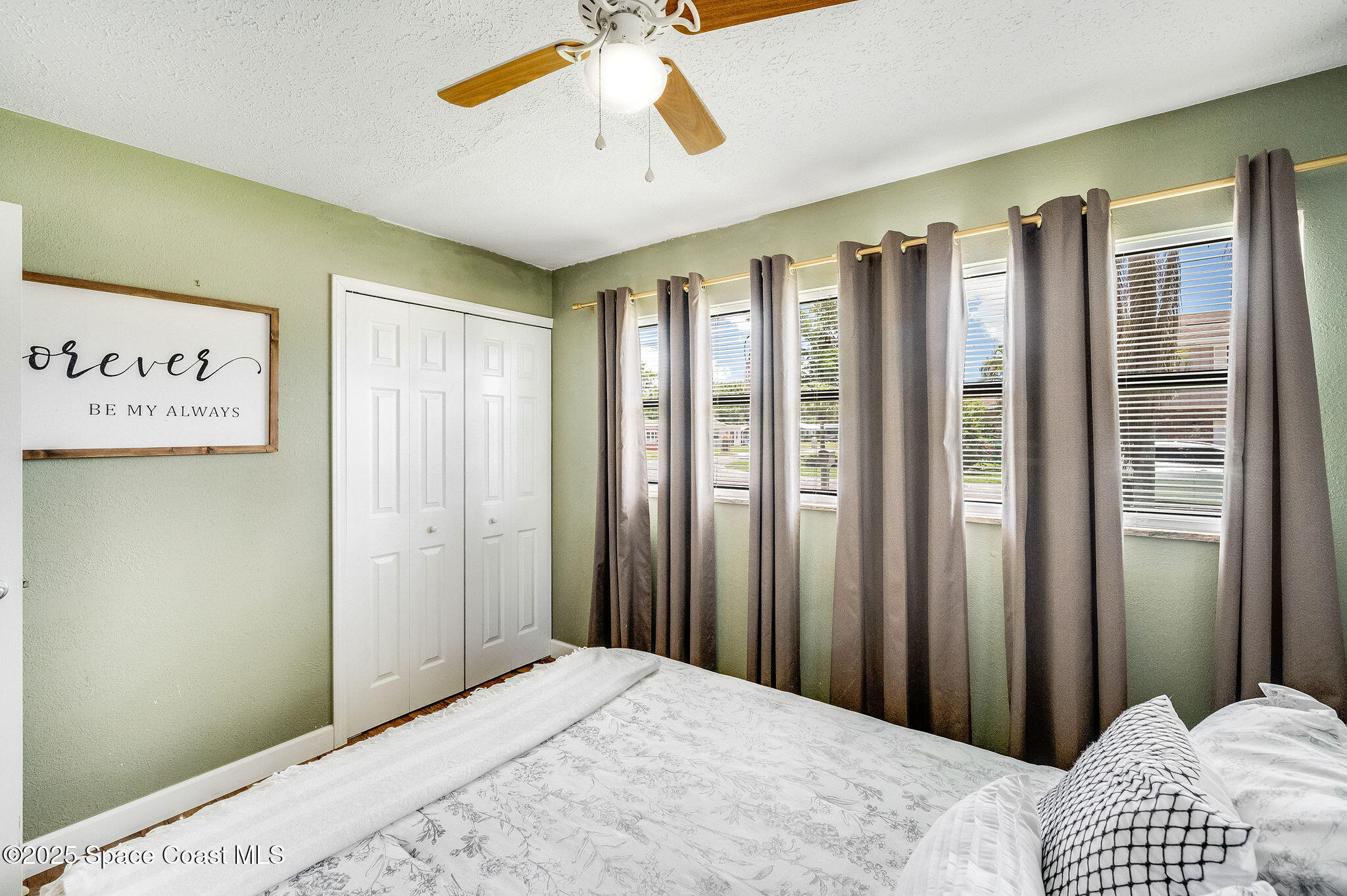 369 Western Avenue Cocoa, FL 32926 - Photo 16 of 38 a bedroom with a bed and a chandelier