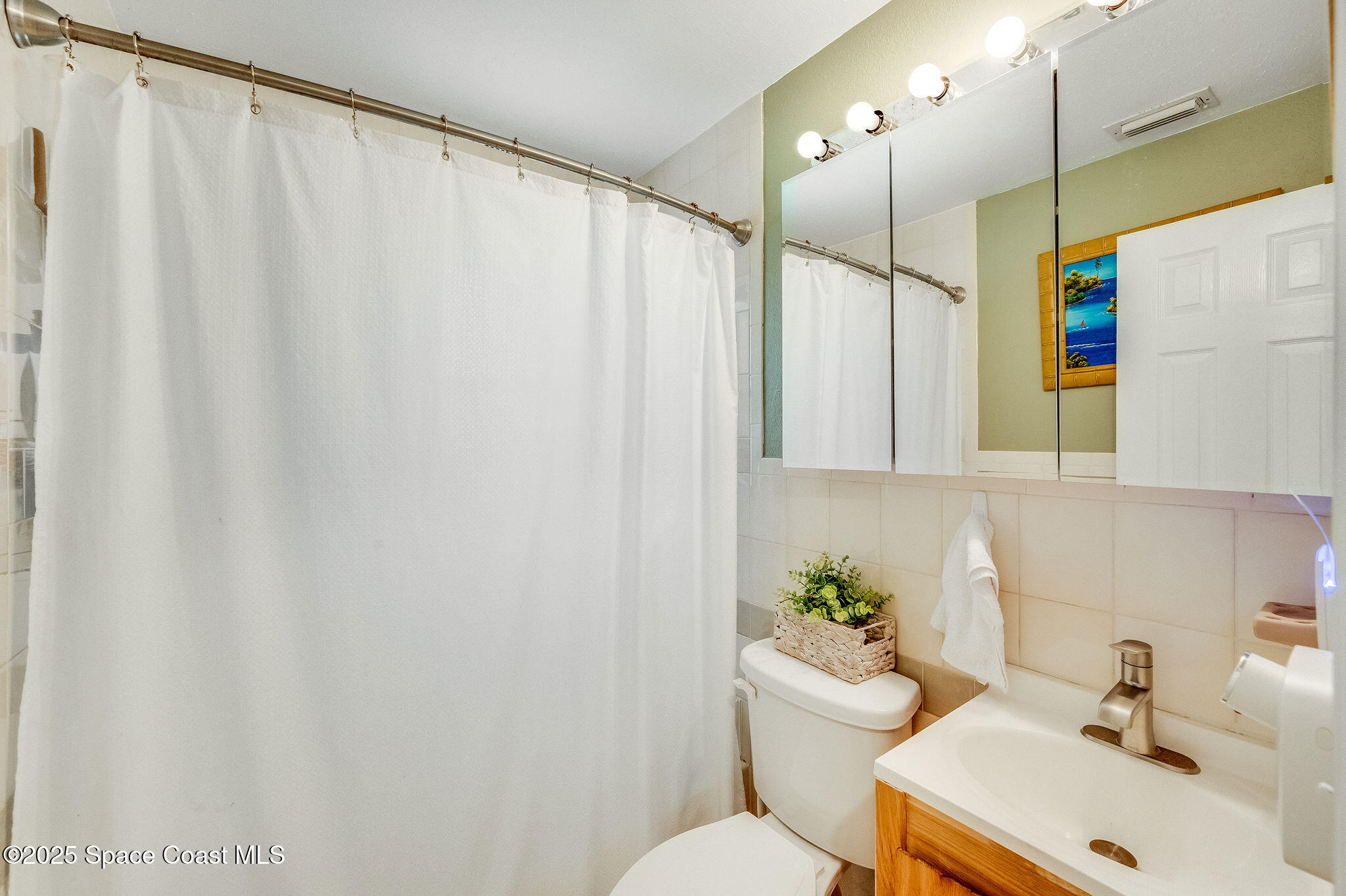 369 Western Avenue Cocoa, FL 32926 - Photo 22 of 38 a bathroom with a sink a toilet and a mirror