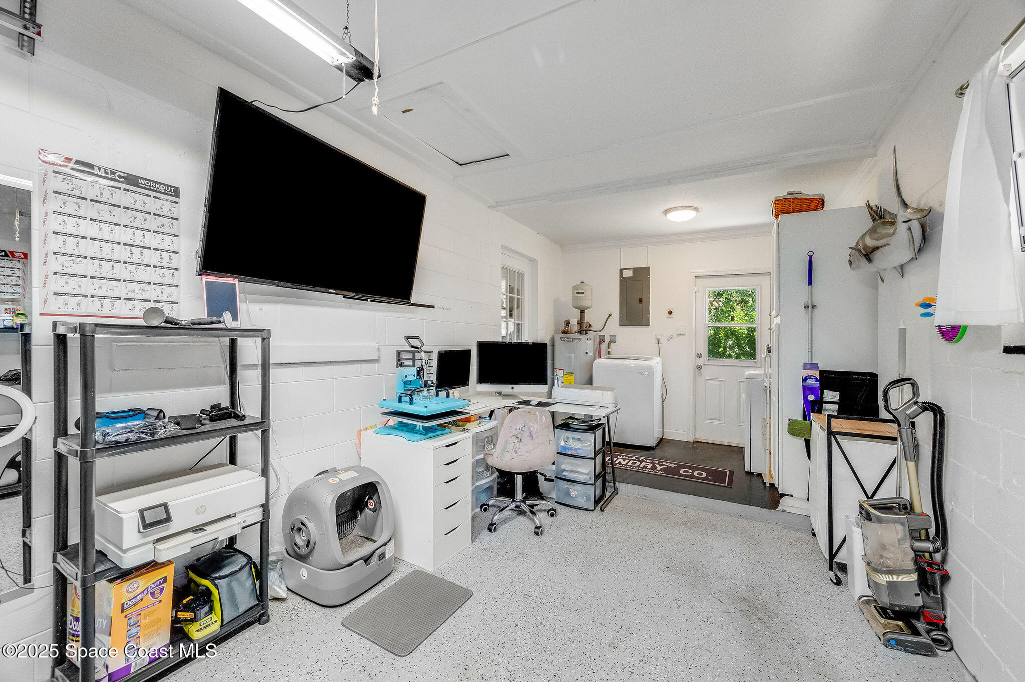 369 Western Avenue Cocoa, FL 32926 - Photo 24 of 38 a view of a livingroom with workspace and a flat screen tv