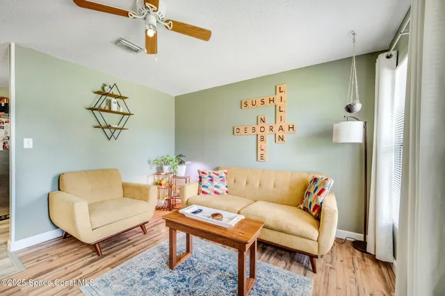 a living room with furniture and wooden floor