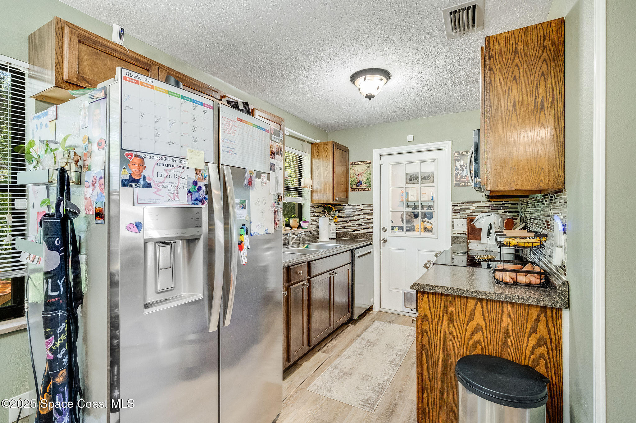 369 Western Avenue Cocoa, FL 32926 - Photo 9 of 38 a kitchen with stainless steel appliances a refrigerator sink and stove
