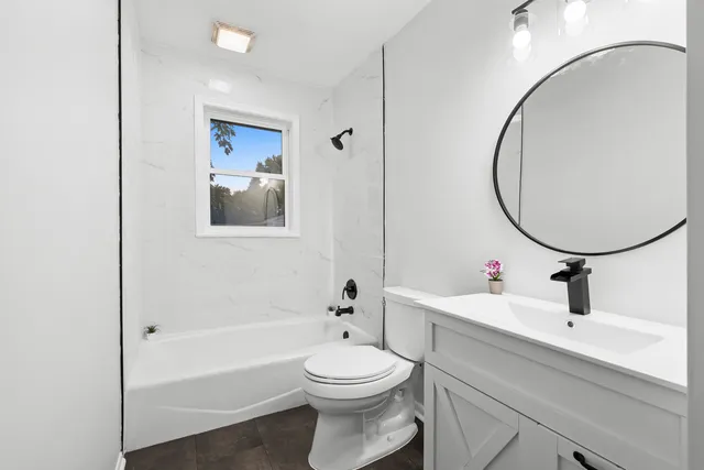 a bathroom with a sink a toilet and a mirror