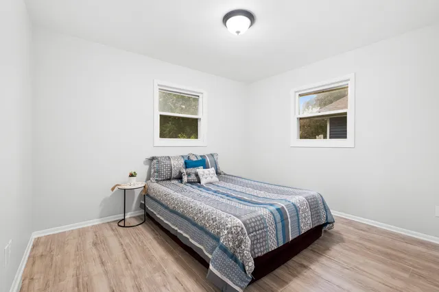 a bedroom with a bed and a window