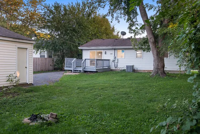a view of a house with a yard and tree s