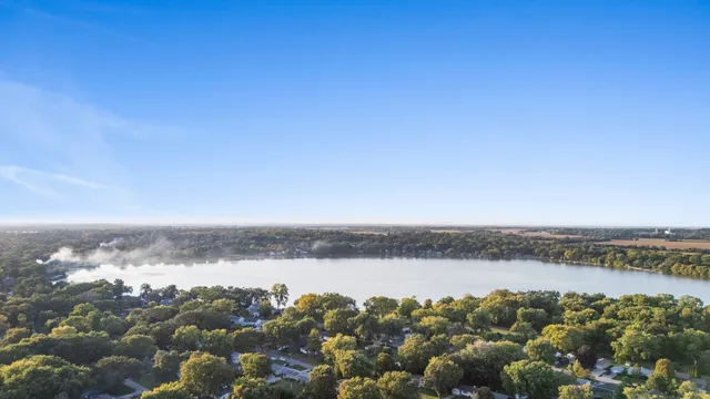 an aerial view of ocean and trees