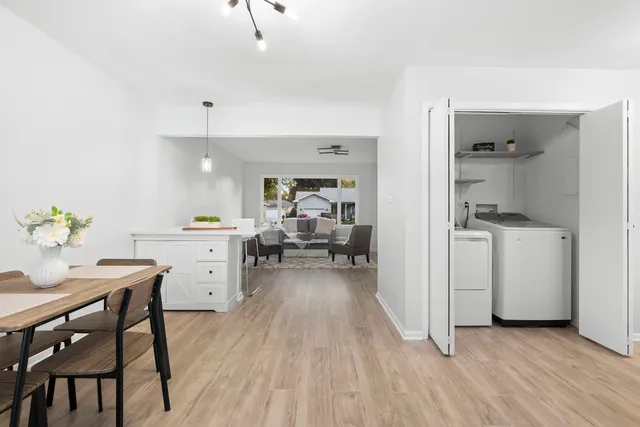 a view of a kitchen and dining room with furniture wooden floor and a window